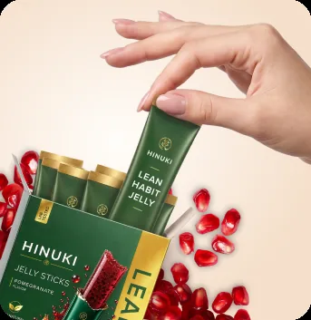 A hand pulling a single Hinuki Lean Habit Jelly stick from the resealable pouch of ten sticks.
